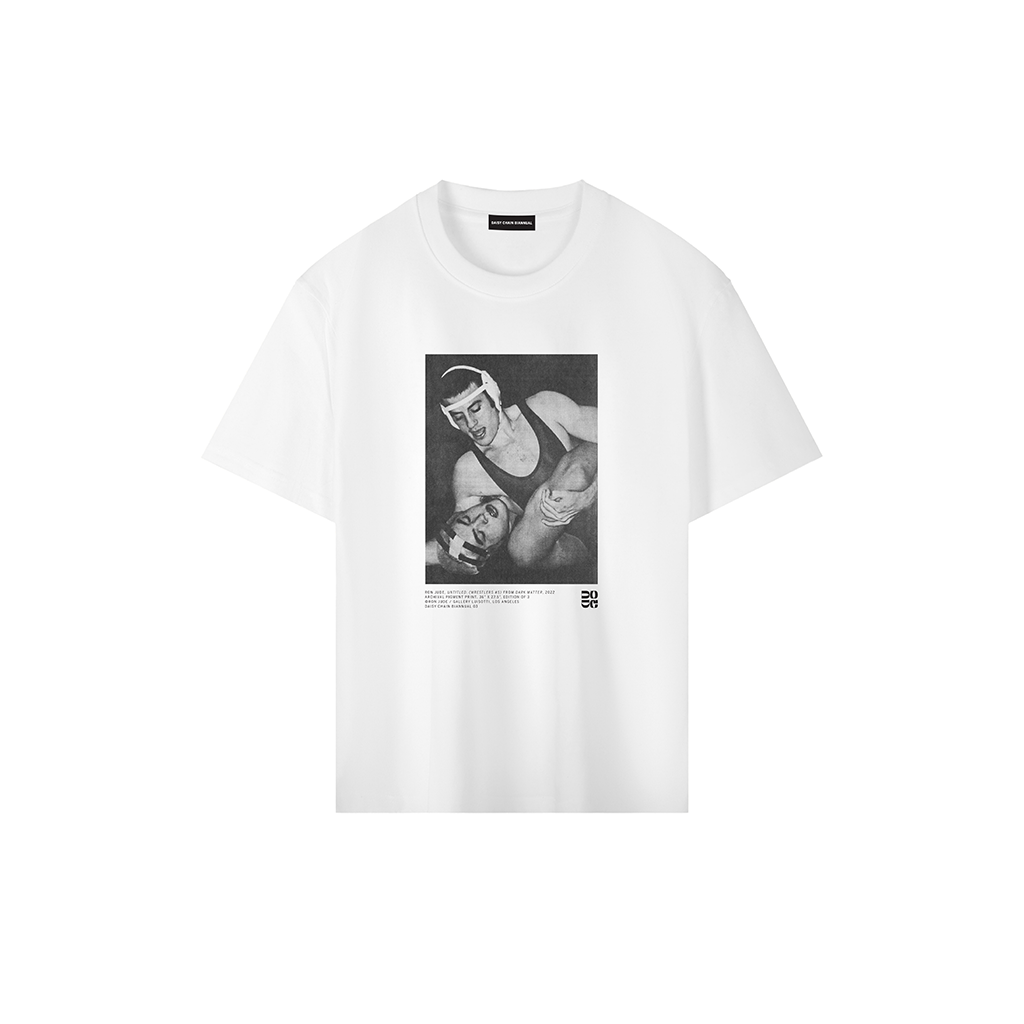 Ron Jude Wrestlers #5 print on a white heavyweight drop shoulder t-shirt. The graphic shows two wrestlers in a high-intensity hold with visible photo-mechanical grain.